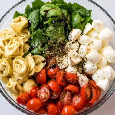 Delicious Caprese salad with tortellini, fresh tomatoes, mozzarella, and basil