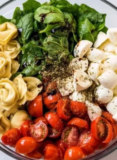 Delicious Caprese salad with tortellini, fresh tomatoes, mozzarella, and basil