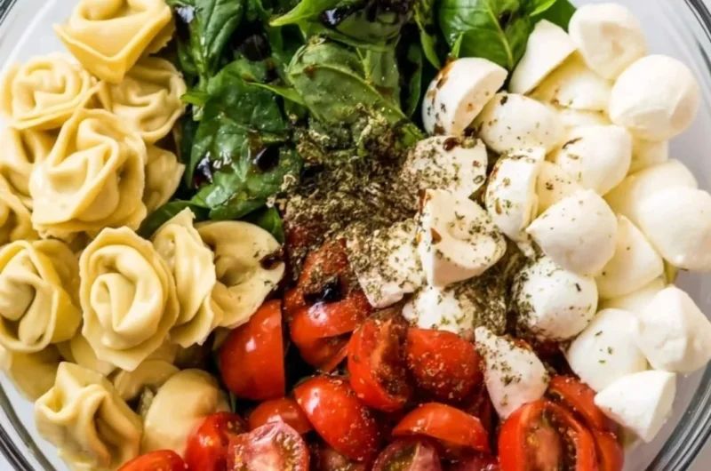 Delicious Caprese salad with tortellini, fresh tomatoes, mozzarella, and basil