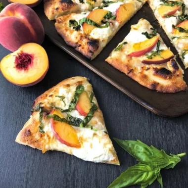 Easy Peach Basil Naan Pizza topped with fresh basil and peaches
