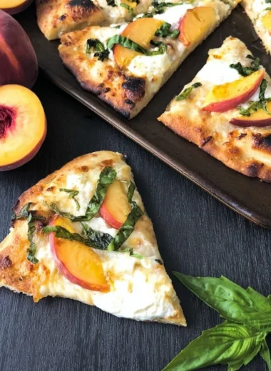 Easy Peach Basil Naan Pizza topped with fresh basil and peaches