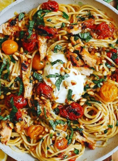 Plate of Lemon Butter Garlic Chicken Pasta with roasted cherry tomatoes and burrata cheese