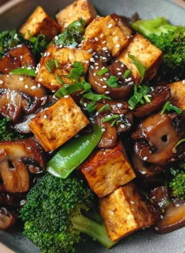 Delicious mushroom and tofu stir-fry served in a colorful bowl with vegetables