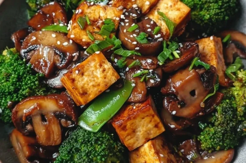 Delicious mushroom and tofu stir-fry served in a colorful bowl with vegetables