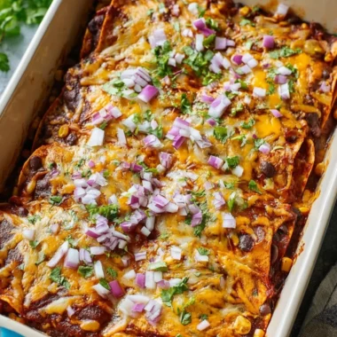 Delicious vegetarian enchilada casserole topped with cheese and fresh ingredients