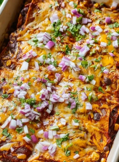 Delicious vegetarian enchilada casserole topped with cheese and fresh ingredients