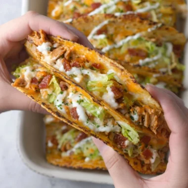 Baked chicken bacon ranch tacos topped with fresh ingredients and spices
