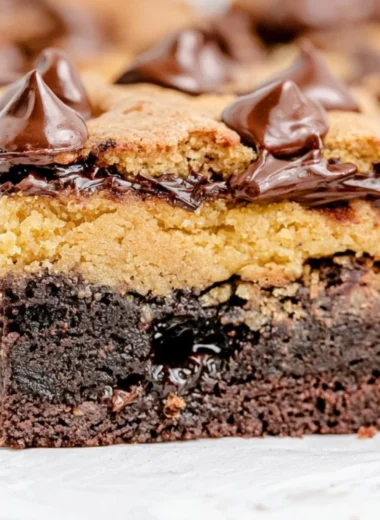 Delicious brown butter brookies served on a plate with chocolate chips.