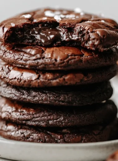 Delicious brownie cookies stacked on a plate with chocolate chips on top