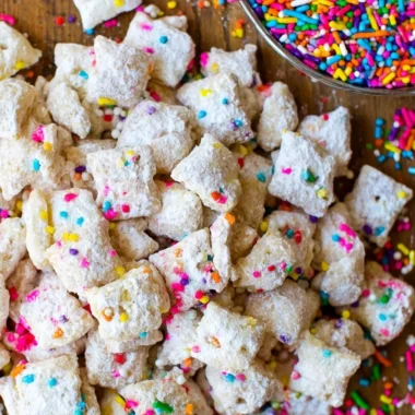 Bowl of delicious Cake Batter Puppy Chow with colorful sprinkles