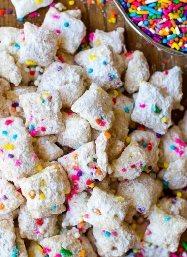 Bowl of delicious Cake Batter Puppy Chow with colorful sprinkles