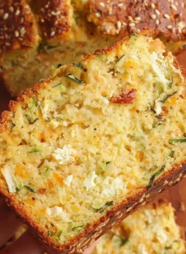 Cheesy zucchini bread freshly baked with a golden crust.