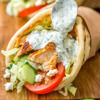 Delicious chicken gyro with fresh vegetables and creamy sauce