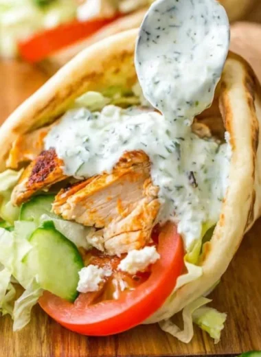 Delicious chicken gyro with fresh vegetables and creamy sauce