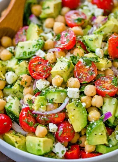 Colorful chickpea salad with vegetables and dressing in a bowl