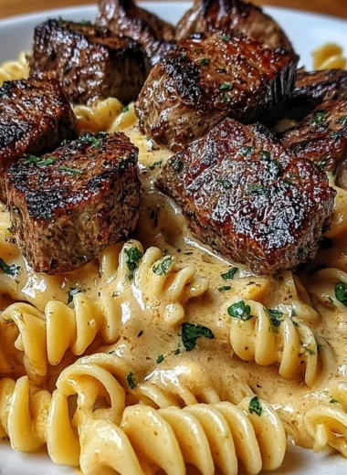 Creamy garlic butter steak bites with spicy Cajun Alfredo twisted pasta