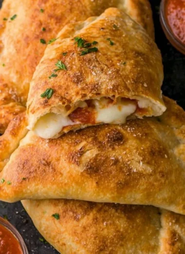 Homemade easy calzones filled with cheese and toppings