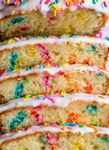 Slice of Funfetti Pound Cake with colorful sprinkles on top