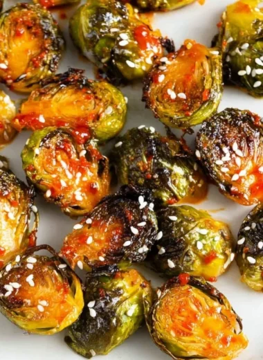 Gochujang roasted Brussels sprouts served in a bowl garnished with sesame seeds