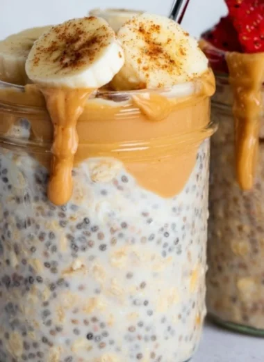 Bowl of high-protein overnight oats topped with fruits and nuts