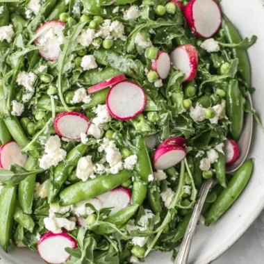 Fresh sugar snap pea salad with vibrant vegetables and dressing