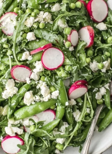 Fresh sugar snap pea salad with vibrant vegetables and dressing