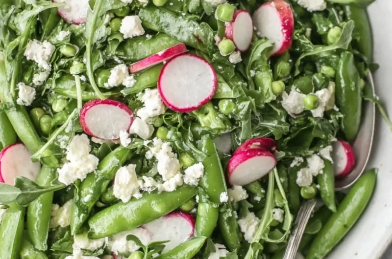 Fresh sugar snap pea salad with vibrant vegetables and dressing
