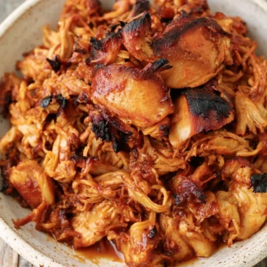 Instant Pot BBQ Pulled Chicken served in a bowl with coleslaw and bread