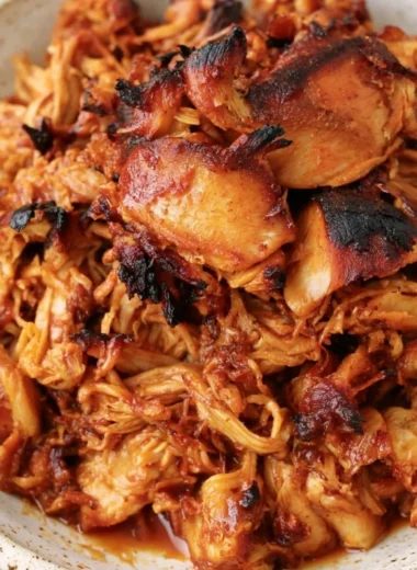 Instant Pot BBQ Pulled Chicken served in a bowl with coleslaw and bread