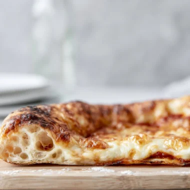 Homemade artisan pizza dough with a crispy, chewy crust ready for baking.