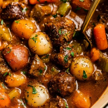Delicious homemade beef stew in a bowl with vegetables and herbs