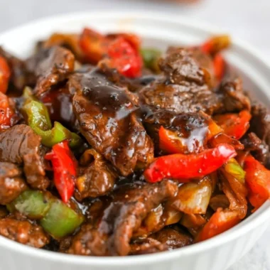 Plate of black pepper beef with colorful vegetables
