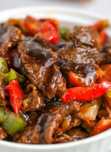 Plate of black pepper beef with colorful vegetables