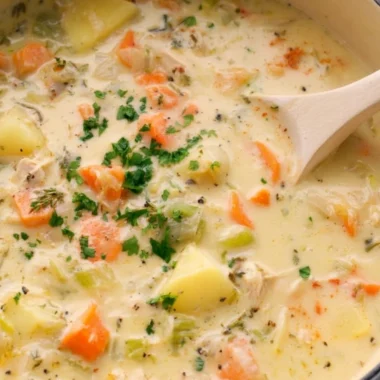 Bowl of easy leftover turkey soup garnished with herbs
