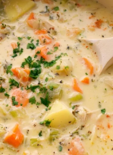 Bowl of easy leftover turkey soup garnished with herbs