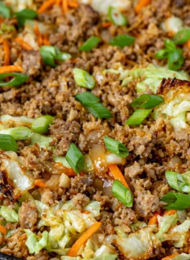 Egg roll in a bowl with colorful vegetables and savory sauce