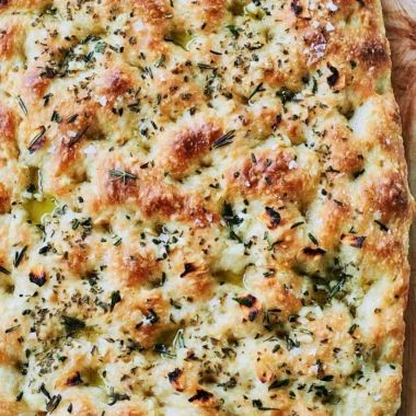 Homemade focaccia bread with herbs and olive oil