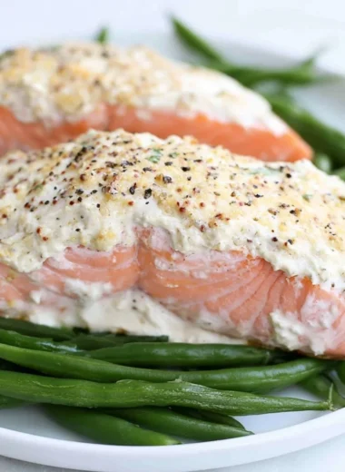 Moist baked salmon garnished with herbs on a plate