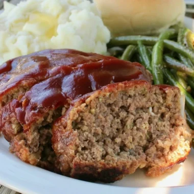 Delicious old fashioned meatloaf served with mashed potatoes and green beans.