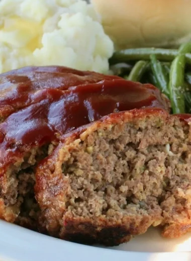 Delicious old fashioned meatloaf served with mashed potatoes and green beans.