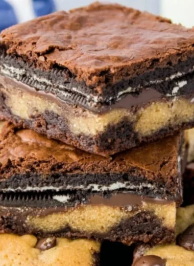 Delicious Oreo brownies topped with cookie dough in a baking dish.
