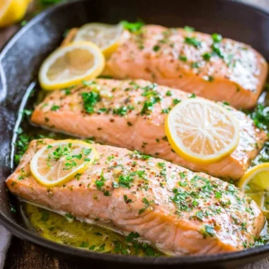 Delicious oven roasted salmon garnished with herbs and lemon