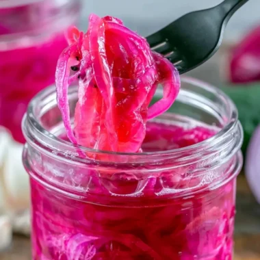 Quick pickled red onions in a jar with vibrant colors and flavors.