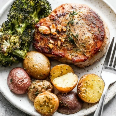 Sheet pan pork chops with roasted potatoes and broccoli ready to serve.
