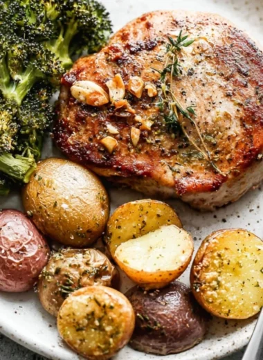 Sheet pan pork chops with roasted potatoes and broccoli ready to serve.
