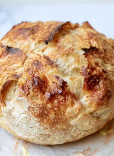 Freshly baked sourdough croissant bread with golden flaky layers