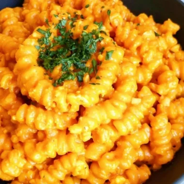 Delicious spicy pepper paste pasta garnished with fresh herbs