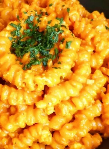 Delicious spicy pepper paste pasta garnished with fresh herbs