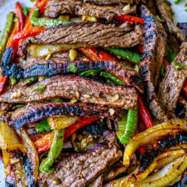 Delicious steak fajitas with grilled peppers and onions served on a plate