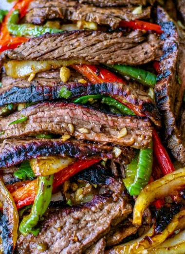 Delicious steak fajitas with grilled peppers and onions served on a plate